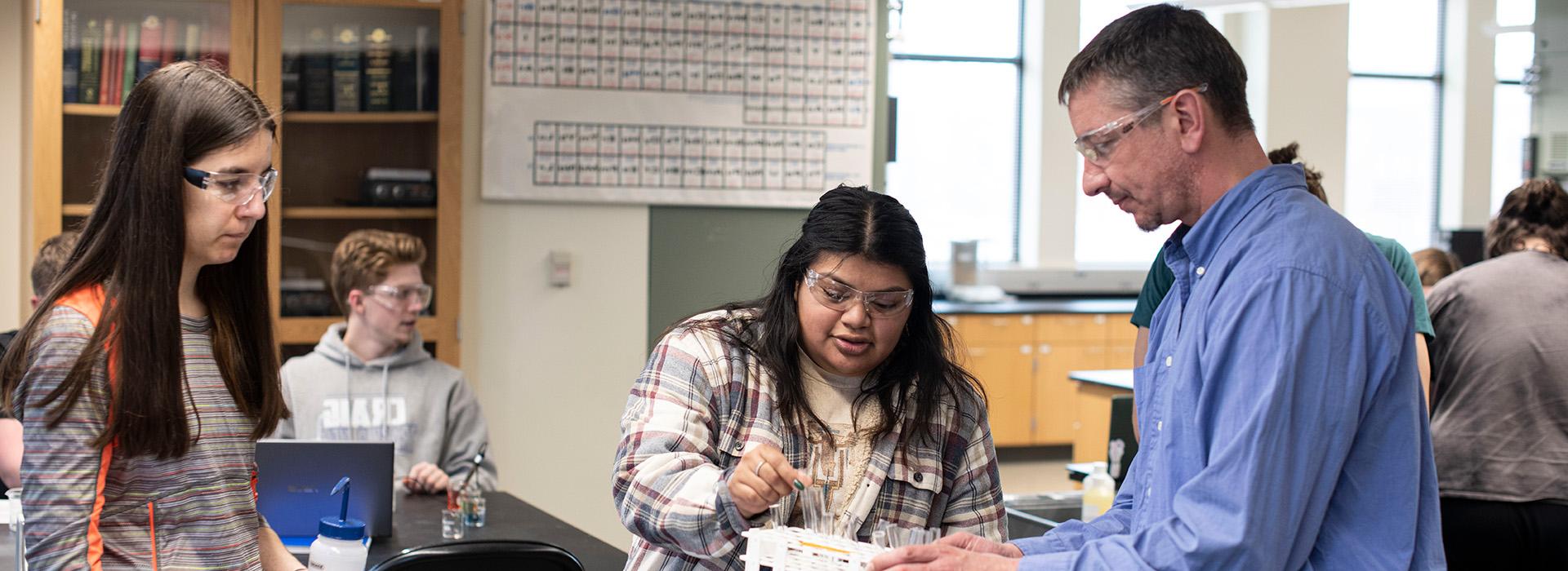 Professor with students in a chemistry lab